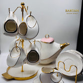 White ceramic tea set with gold accents on a stand, featuring the brand 'BANTAN'.