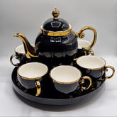 Black and gold teapot set with four cups on a tray, featuring the BARTAN House Hold brand.