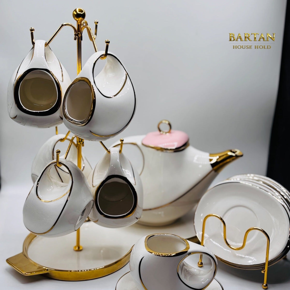 White ceramic tea set with gold accents on a stand, featuring the brand 'BANTAN'.